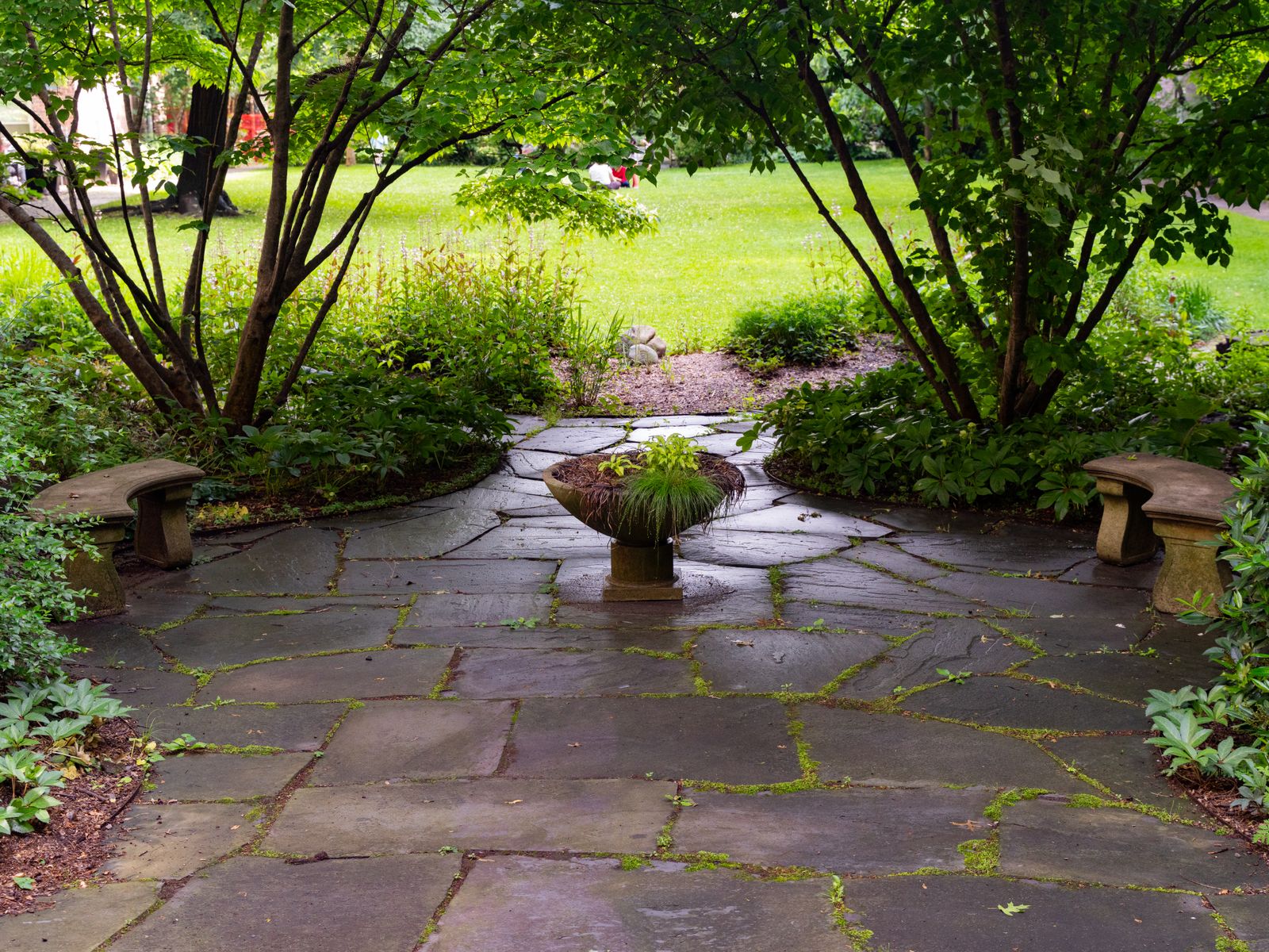 Stone patio and landscaped garden bed
