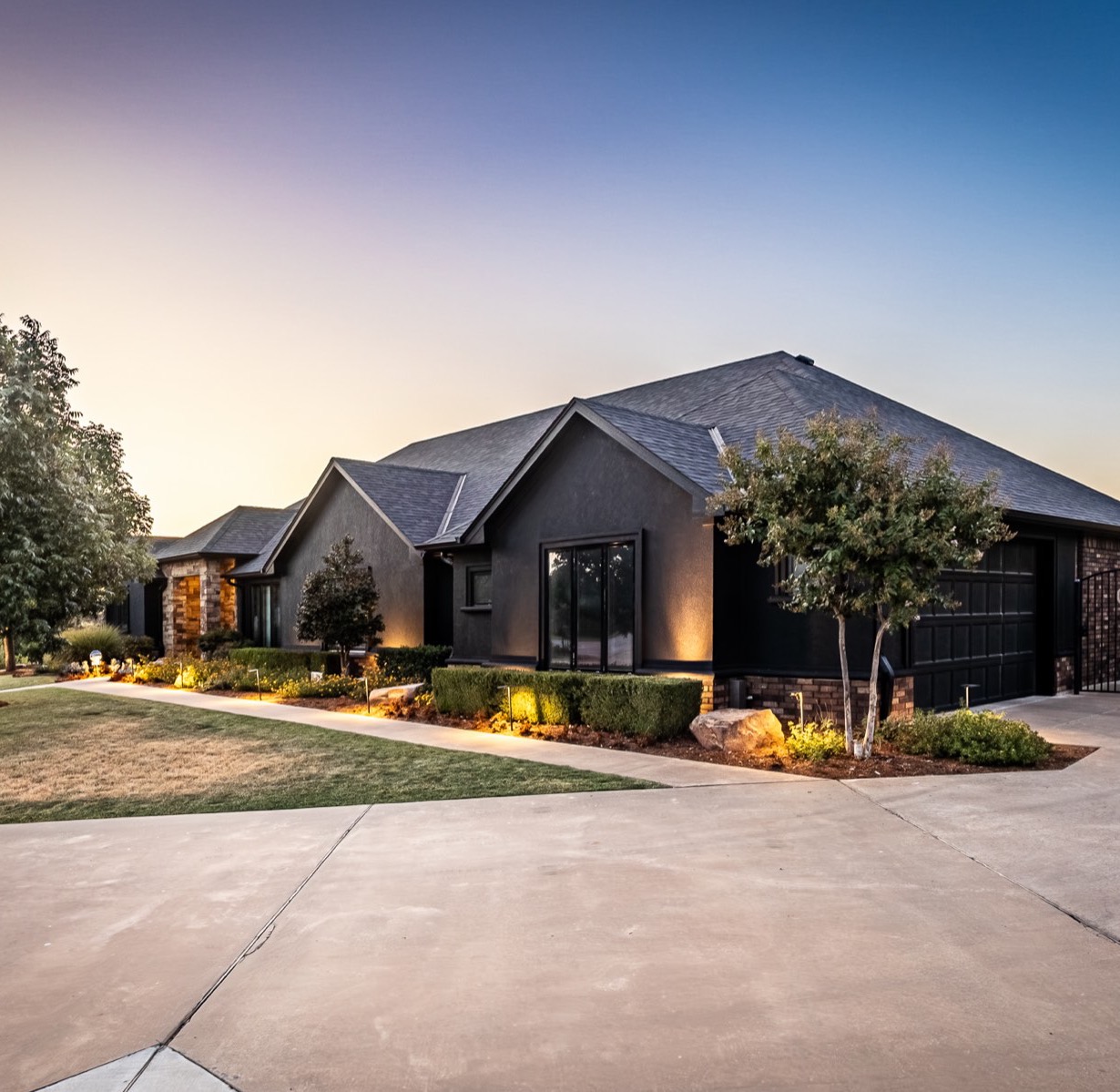 Landscaped modern home exterior at dusk